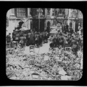 Soldiers praying in damaged cathedral