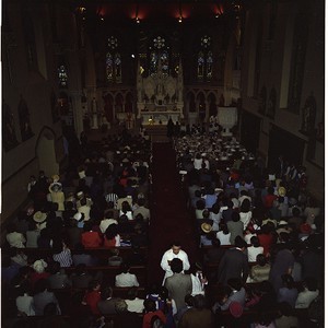 First Holy Communion, Downpatrick Church. Large group of children with clergy seated in front, on steps of Church