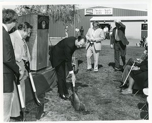 Robsham Theatre exterior: groundbreaking, J. Donald Monan with shovel turning sod