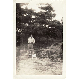 A double exposure of a man in a field and in front of some houses