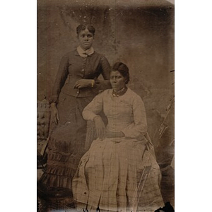 Two African American women in pleated skirts