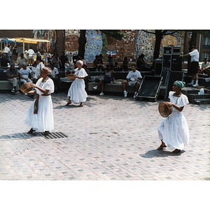Three women performing a folk dance in the plaza at Festival Betances.