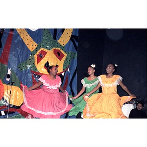 Girls performing a folk dance on stage.