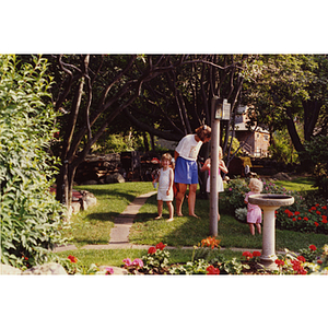 A woman and three children standing in a garden during a Boys and Girls Club Board outing