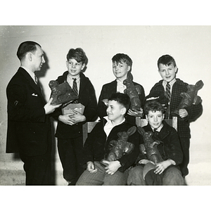 Five boys and a man pose with chocolate Easter bunnies