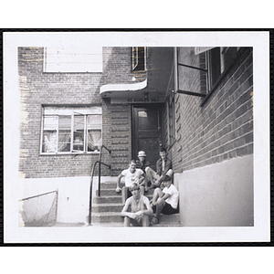 Five teenage boys from the Charlestown Boys' Club sitting on the front steps at 65 Bunker Hill Street