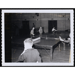 Boys play table tennis in a hall