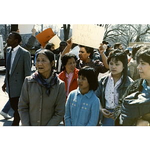 Adults and children of several ethnic communities stand on Beacon Street opposite the Massachusetts State House, protesting for bilingual education in schools