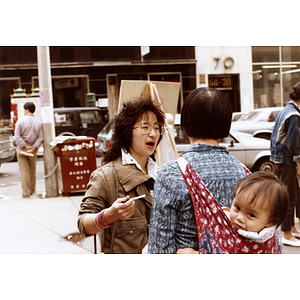 Community volunteer collects signatures at the corner of Beach Street and Harrison Avenue in Chinatown on behalf of Long Guang Huang