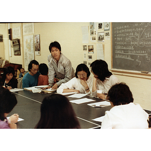 Students gathered around a large table in a job training class