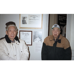 Chinese Progressive Association members walk in front of wall with veterans' honors