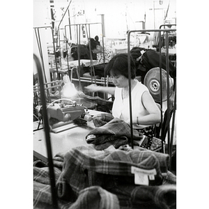 Garment worker sewing jackets