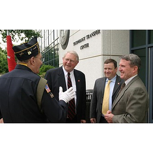 A man in military uniform converses with three others at the Veterans Memorial groundbreaking ceremony