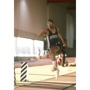 A Northeastern student from the men's indoor track and field team competing in the Greater Boston Championships at Harvard