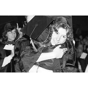 Two graduates hug at Law School commencement