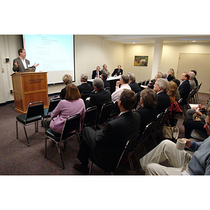 Peter Barrett, PhD '79, gestures at the podium during the NU Today Cancer Research Panel