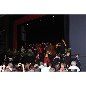 Faculty members walk onstage at School of Nursing convocation