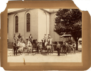 Group of men in or next to wagons in front of the Charles Street Meeting House, Boston, Mass., 1890