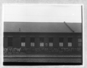 View of a building with advertising graffiti, probably on Dorchester Ave.