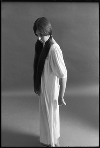 Full-length studio portrait of a model in a loose-fitting shift