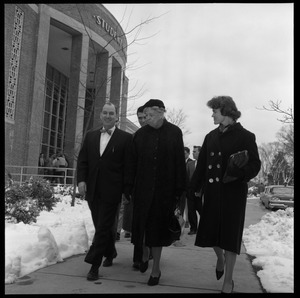Eleanor Roosevelt (center) walking past the Student Union building with John Gillespie (left) and Gail Osbaldeston (right), during Roosevelt's Distinguished Visitors Program appearance
