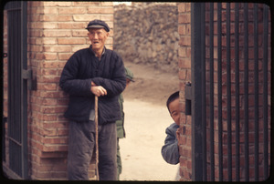 General Petrochemical Works -- old man, child peeping around wall, laughing