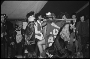 Yippies on stage at the Counter-inaugural Ball, 1969: naked man in an Uncle Sam hat dances with a Yippie! flag
