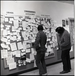 Students looking at a bulletin board in the UMass Amherst Student Union Building