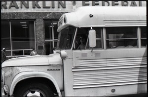 Free Spirit Press bus parked on street outside Franklin Federal Credit Union
