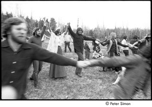 May Day at Packer Corners commune: group holding hands and dancing