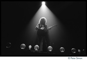 Jimmy Page (guitar) backlit with a spotlight on stage with Led Zeppelin during their Physical Graffiti tour