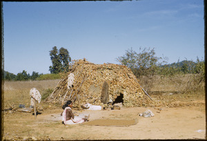 Birhor woman outside hut