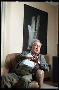 Fine art photographer Aaron Siskind: seated in a armchair in his living room