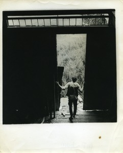 Man standing in the barn doorway, Montague Farm Commune