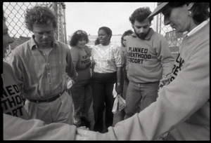 Escorts ushering a woman into the Planned Parenthood clinic in Providence