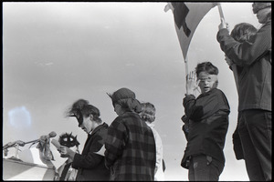 Anti-war rally at Soldier's Field, Harvard University: members of feminist group Bread and Roses speaking while wearing masks
