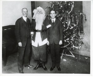 Two unidentified men and a client dressed as Santa Claus