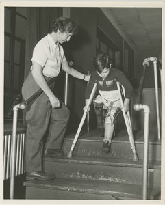 Boy walking on crutches during physical rehabilitation