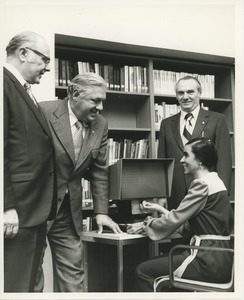 Woman demonstrates using the optiscope enlarger