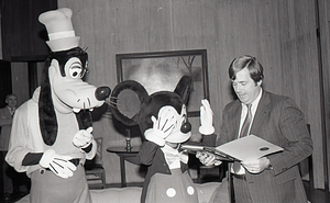 Man with Disney characters Mickey Mouse and Goofy