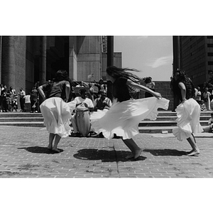 Girls dance barefoot in front of drummers at Boston's City Hall Plaza