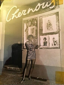 A Photograph of Marlow Monique Dickson Posing in Front of Chez Nous