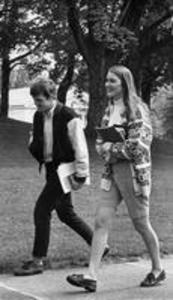 Male and female student walk to class, 1969