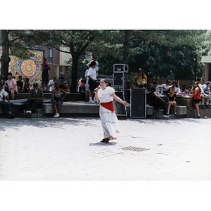 Young woman performs a song in the center of the plaza for Festival Betances spectators.