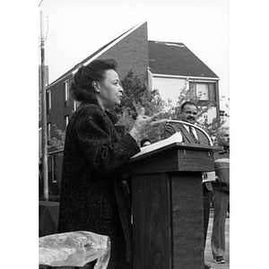 Woman addresses attendees at the ceremonial installation of the Peace Rock.