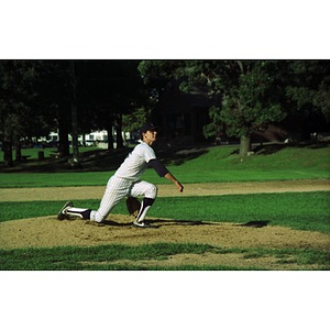 Baseball pitcher on the mound in a park.