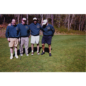 A four-man golf team in commemorative shirts posing at the Charlestown Boys & Girls Club Annual Golf Tournament