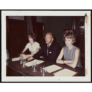 The panel of judges, including Charles H. Hood, at center, sit at a table at a Boys' Club Little Sister Contest