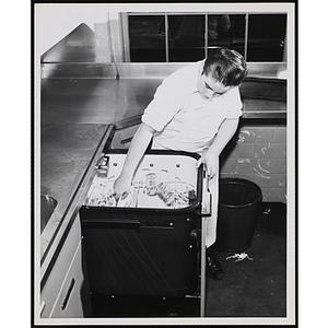 A member of the Tom Pappas Chefs' Club operates a dishwasher in the new kitchen of the Bunker Hill Clubhouse