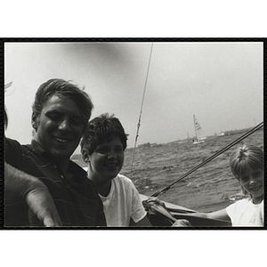 A Group of youth smile during a sailing trip